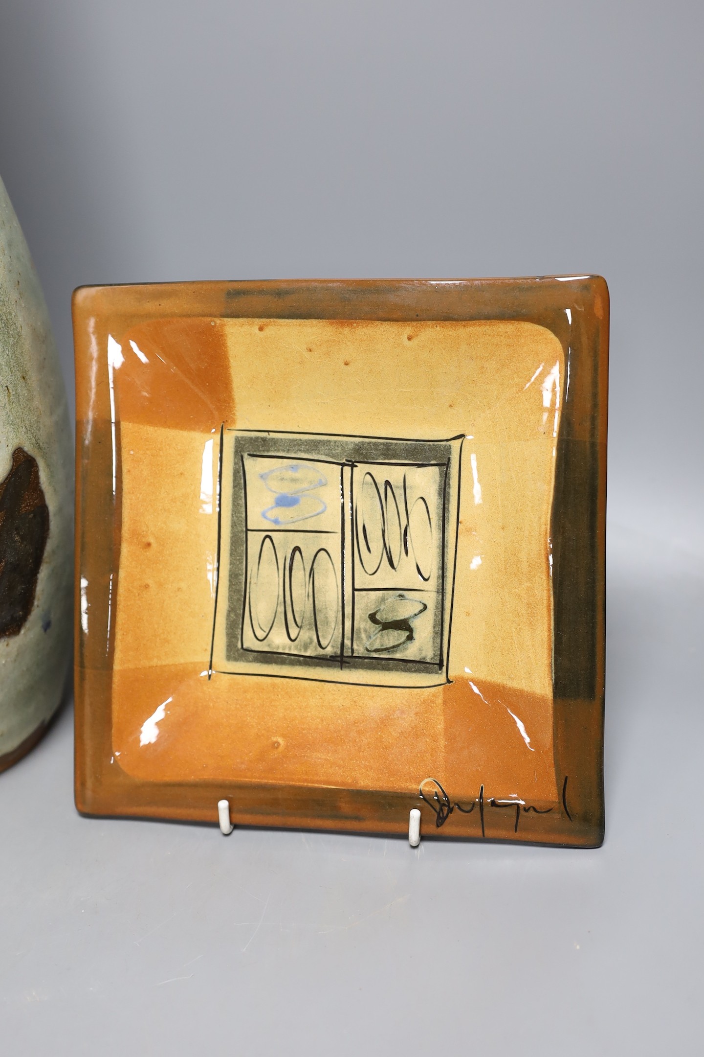 A signed large studio pottery ewer and glazed pottery square dish, signed, ewer 49 cms high.